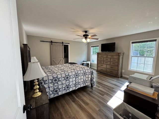 111 Stellar Ct, Clarkrange, TN 38553 - bedroom with wood finished floors, a barn door, baseboards, and a ceiling fan