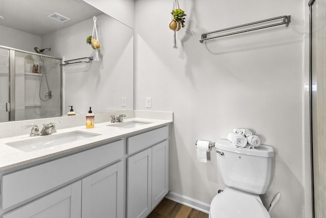 2563 Drumwright Way, Columbia, TN 38401 - bathroom featuring a shower stall, double vanity, toilet, wood finished floors, and baseboards