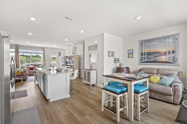 2563 Drumwright Way, Columbia, TN 38401 - kitchen with open floor plan, stainless steel fridge, a sink, light wood-style floors, and recessed lighting