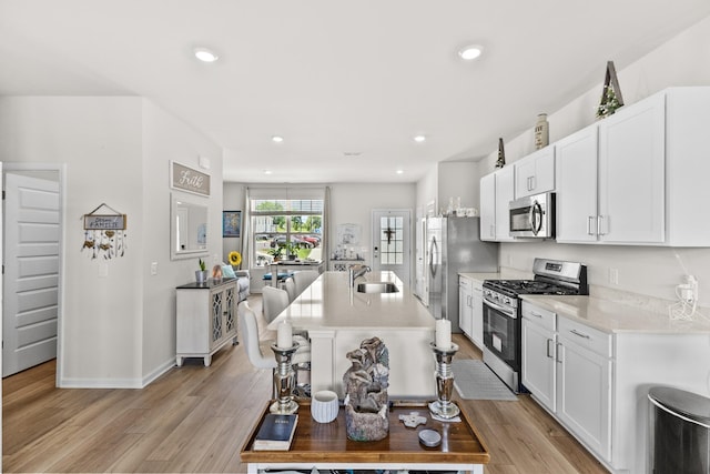 2563 Drumwright Way, Columbia, TN 38401 - kitchen featuring stainless steel appliances, light countertops, white cabinetry, light wood finished floors, and recessed lighting