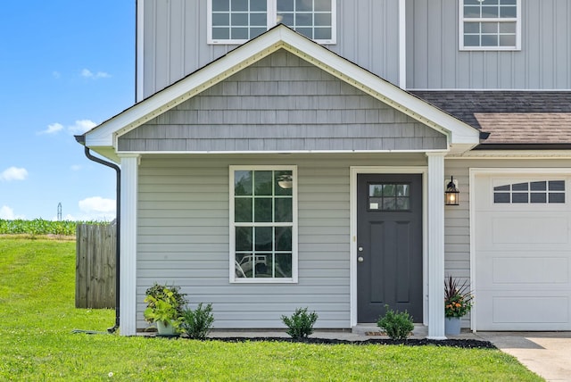 157 Bob White Trl, Oak Grove, KY 42262 - view of front facade with a garage, board and batten siding, a front yard, and a shingled roof