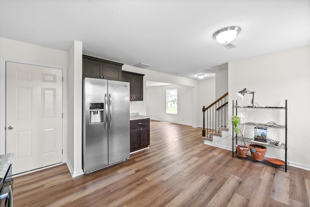 157 Bob White Trl, Oak Grove, KY 42262 - kitchen featuring stainless steel fridge with ice dispenser, light wood finished floors, light countertops, baseboards, and dark brown cabinets