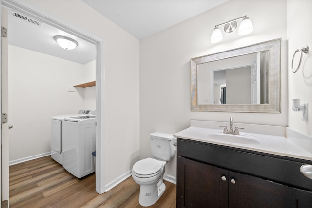 157 Bob White Trl, Oak Grove, KY 42262 - bathroom featuring washer and clothes dryer, wood finished floors, toilet, vanity, and baseboards