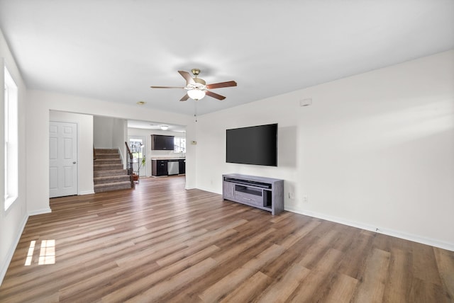 157 Bob White Trl, Oak Grove, KY 42262 - unfurnished living room with stairway, ceiling fan, wood finished floors, and baseboards