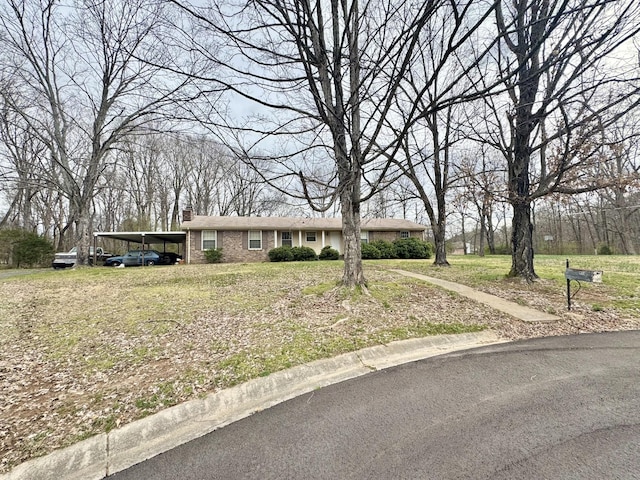 345 Lockert Pl, Clarksville, TN 37043 - view of front of property featuring a chimney, brick siding, a front yard, and an attached carport