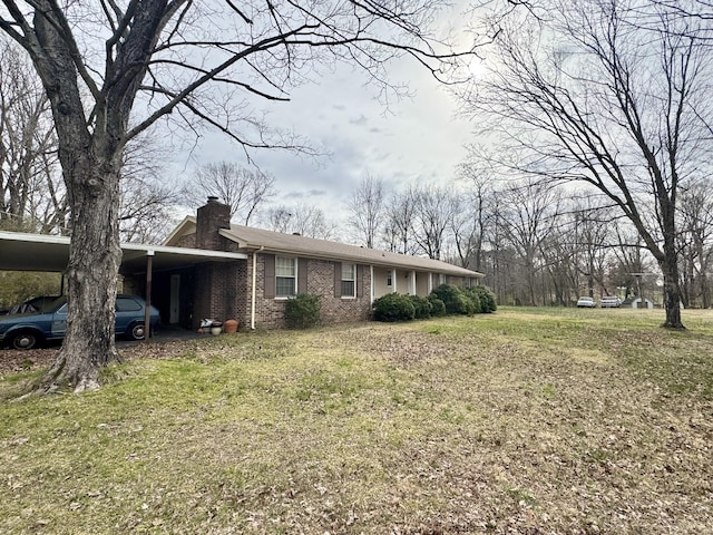345 Lockert Pl, Clarksville, TN 37043 - view of front of property with a chimney, brick siding, a front lawn, and a carport