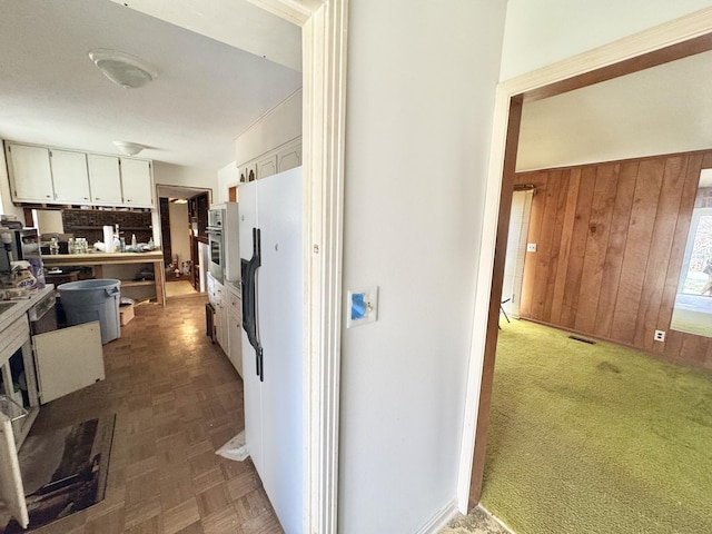 345 Lockert Pl, Clarksville, TN 37043 - kitchen featuring oven, wooden walls, and white cabinets