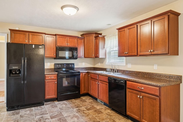1056 Orion Jones Rd, Chapmansboro, TN 37035 - kitchen with black appliances, dark countertops, and brown cabinets