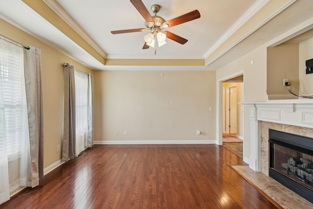 1056 Orion Jones Rd, Chapmansboro, TN 37035 - unfurnished living room with a tray ceiling, wood finished floors, ceiling fan, a tiled fireplace, and crown molding