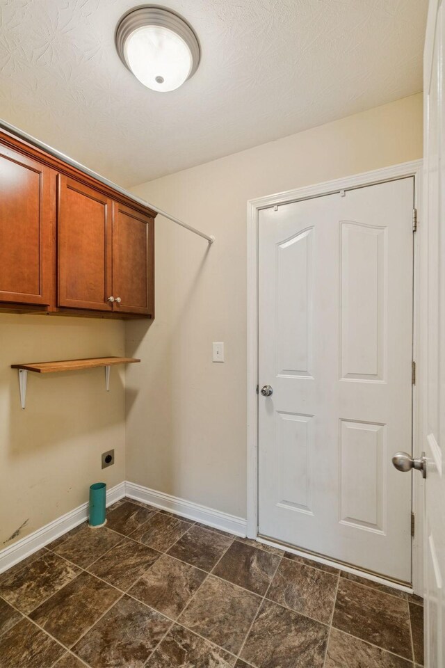 1056 Orion Jones Rd, Chapmansboro, TN 37035 - laundry area with hookup for an electric dryer, cabinet space, and dark stone finish floors