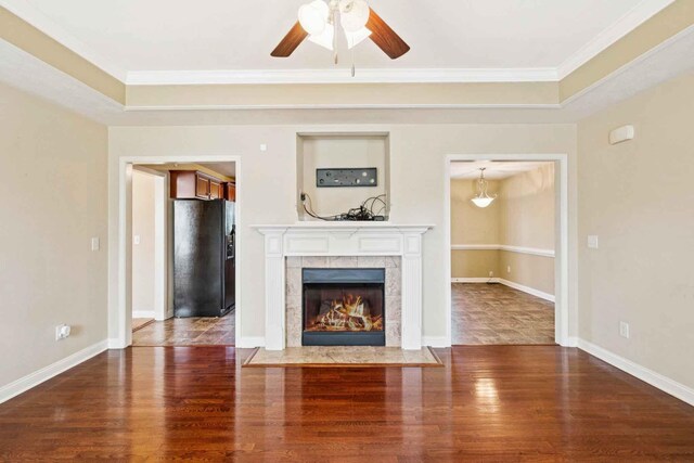 1056 Orion Jones Rd, Chapmansboro, TN 37035 - unfurnished living room with a raised ceiling, wood finished floors, crown molding, a ceiling fan, and a tile fireplace