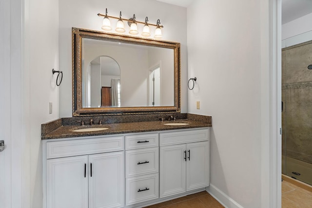 309 Seven Springs Way Unit 404, Brentwood, TN 37027 - bathroom with double vanity, a stall shower, tile patterned floors, and baseboards