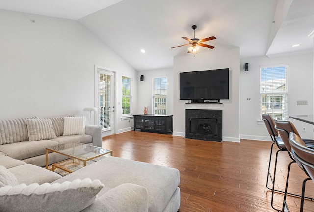 309 Seven Springs Way Unit 404, Brentwood, TN 37027 - living room featuring healthy amount of natural light, ceiling fan, wood finished floors, vaulted ceiling, and a fireplace