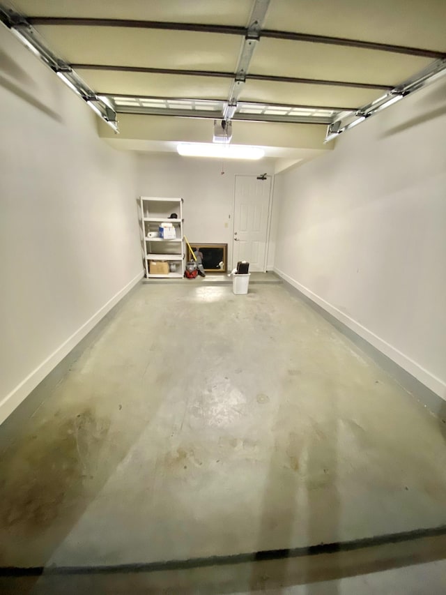 309 Seven Springs Way Unit 404, Brentwood, TN 37027 - garage featuring baseboards and a garage door opener