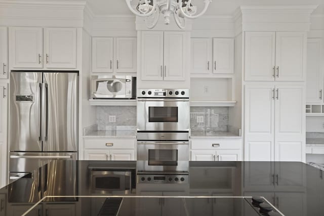 1853 Lafever Ridge Rd, Silver Point, TN 38582 - kitchen featuring appliances with stainless steel finishes, a chandelier, white cabinets, and ornamental molding