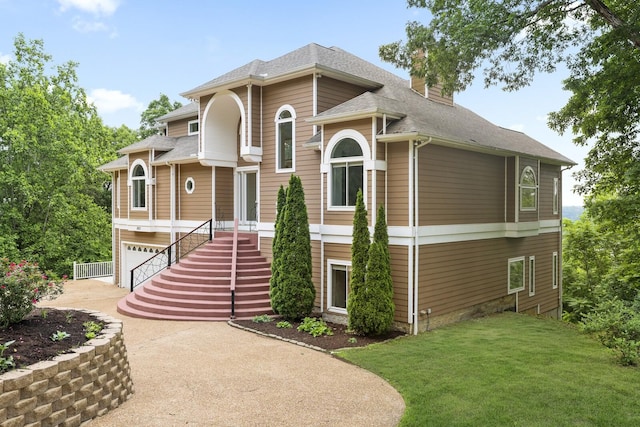 1853 Lafever Ridge Rd, Silver Point, TN 38582 - view of front of property with a chimney, a front yard, driveway, a garage, and a shingled roof