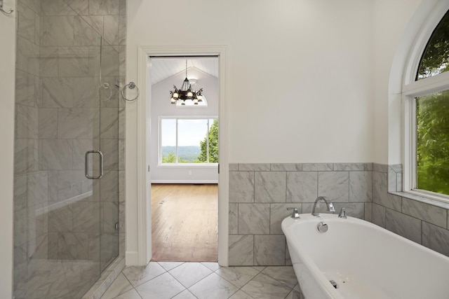 1853 Lafever Ridge Rd, Silver Point, TN 38582 - full bathroom featuring a freestanding tub, a chandelier, a stall shower, and marble look tiles