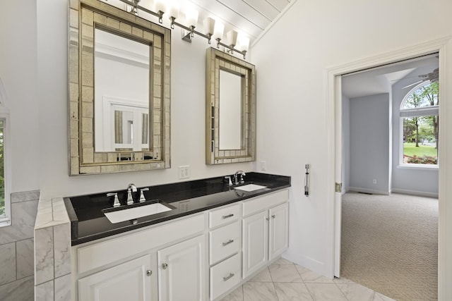 1853 Lafever Ridge Rd, Silver Point, TN 38582 - bathroom featuring double vanity, marble look tiles, and lofted ceiling