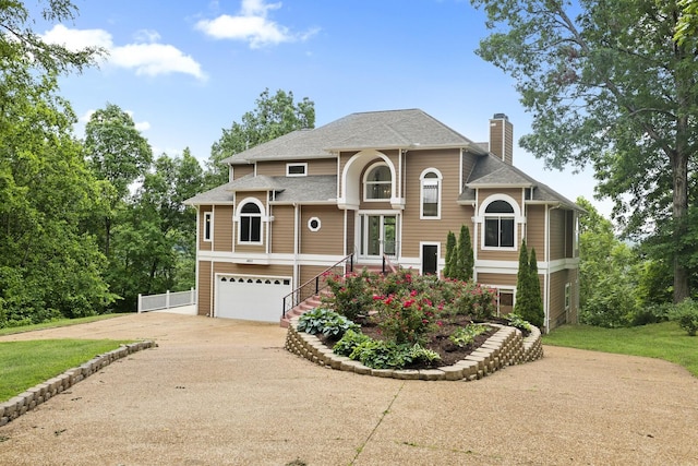 1853 Lafever Ridge Rd, Silver Point, TN 38582 - view of front of property featuring concrete driveway, an attached garage, a chimney, and roof with shingles