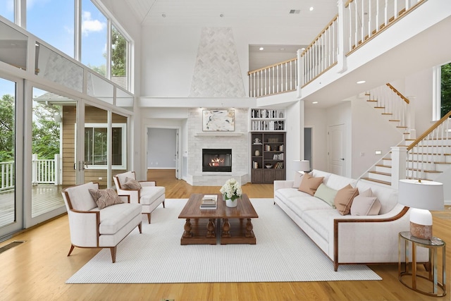 1853 Lafever Ridge Rd, Silver Point, TN 38582 - living area with a high ceiling, wood finished floors, recessed lighting, a tiled fireplace, and stairway