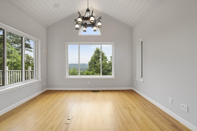 1853 Lafever Ridge Rd, Silver Point, TN 38582 - empty room featuring a chandelier, plenty of natural light, light wood-type flooring, lofted ceiling, and baseboards