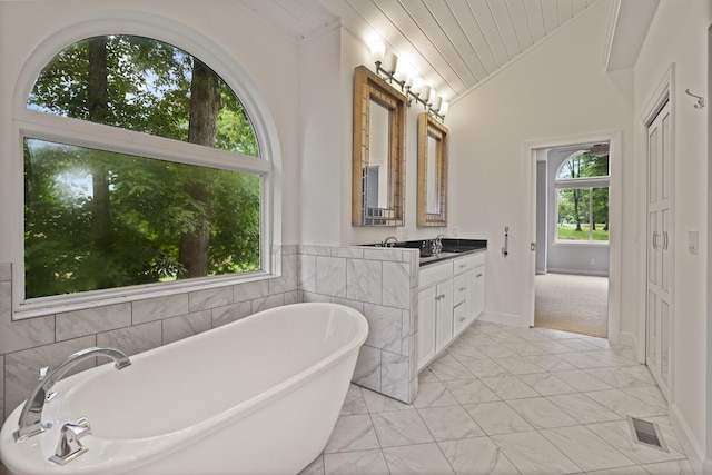 1853 Lafever Ridge Rd, Silver Point, TN 38582 - bathroom featuring lofted ceiling, a soaking tub, vanity, marble finish floors, and wooden ceiling