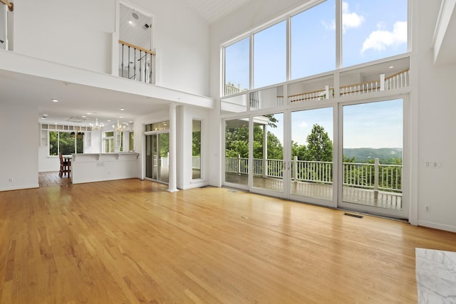 1853 Lafever Ridge Rd, Silver Point, TN 38582 - unfurnished living room featuring high vaulted ceiling, wood finished floors, and baseboards