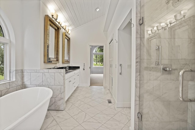 1853 Lafever Ridge Rd, Silver Point, TN 38582 - bathroom with lofted ceiling, vanity, a soaking tub, a stall shower, and marble look tiles