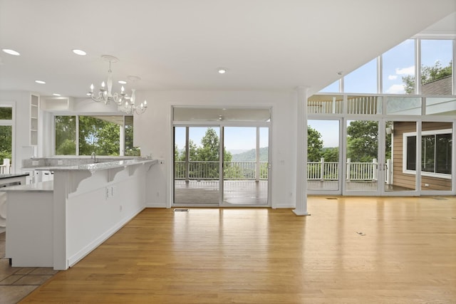 1853 Lafever Ridge Rd, Silver Point, TN 38582 - kitchen featuring light wood-style flooring, baseboards, a chandelier, pendant lighting, and light countertops