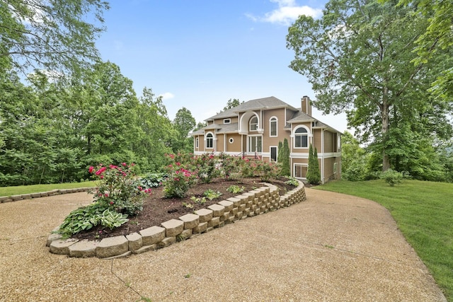 1853 Lafever Ridge Rd, Silver Point, TN 38582 - view of front of home featuring a chimney, concrete driveway, and a front lawn