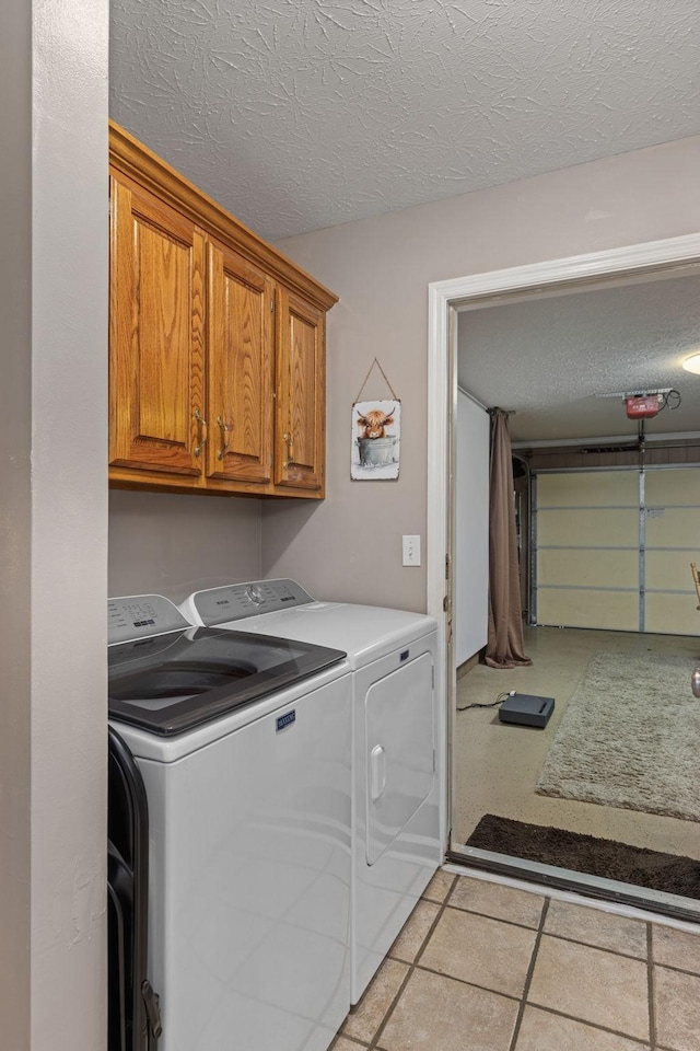 154 Jasons Way, Leoma, TN 38468 - washroom featuring washer and dryer, cabinet space, a textured ceiling, and light tile patterned floors