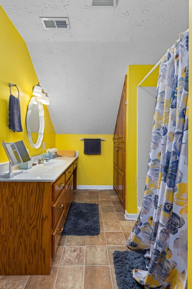 154 Jasons Way, Leoma, TN 38468 - full bathroom with vanity, baseboards, a textured ceiling, vaulted ceiling, and a shower with curtain