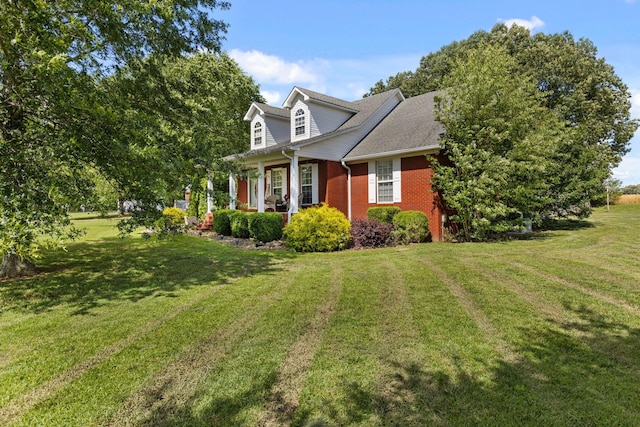 154 Jasons Way, Leoma, TN 38468 - view of home's exterior featuring a porch, brick siding, and a yard