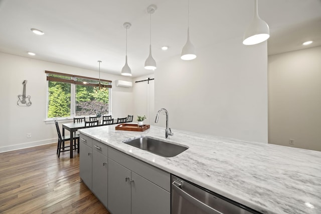 3746 Central Pike Unit 15, Hermitage, TN 37076 - kitchen featuring a sink, wood finished floors, a barn door, a wall mounted air conditioner, and pendant lighting