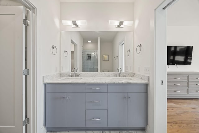 3746 Central Pike Unit 15, Hermitage, TN 37076 - full bathroom featuring a stall shower, double vanity, and wood finished floors
