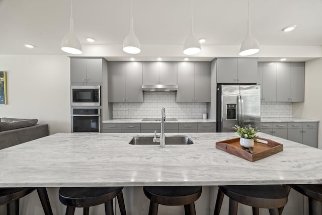 3746 Central Pike Unit 15, Hermitage, TN 37076 - kitchen with gray cabinetry, stainless steel appliances, a sink, under cabinet range hood, and recessed lighting