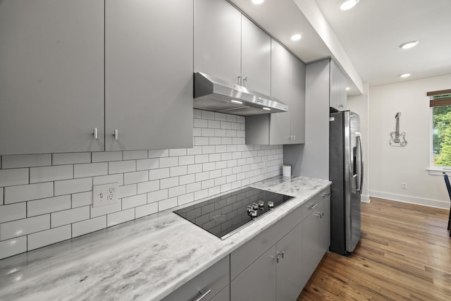 3746 Central Pike Unit 15, Hermitage, TN 37076 - kitchen with stainless steel refrigerator with ice dispenser, under cabinet range hood, black electric cooktop, gray cabinets, and baseboards