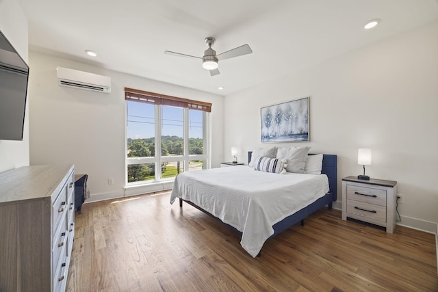 3746 Central Pike Unit 15, Hermitage, TN 37076 - bedroom with an AC wall unit, baseboards, wood finished floors, a ceiling fan, and recessed lighting