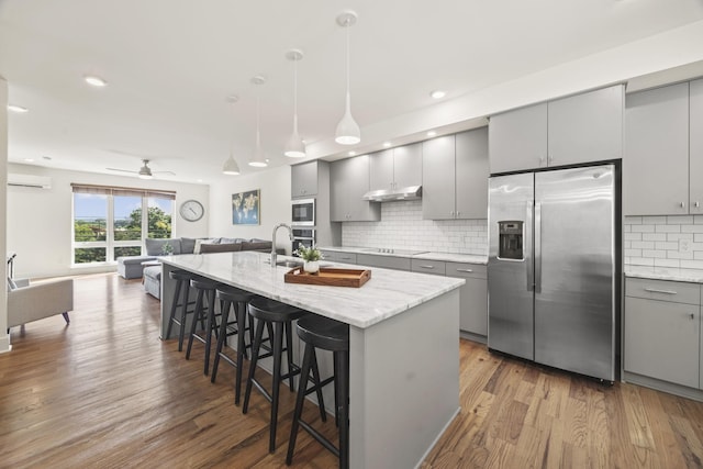 3746 Central Pike Unit 15, Hermitage, TN 37076 - kitchen with stainless steel appliances, gray cabinetry, under cabinet range hood, a wall unit AC, and recessed lighting