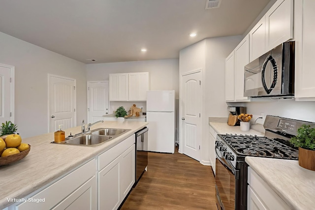 18 Pointer Pl, Lebanon, TN 37087 - kitchen with black microwave, range with gas cooktop, freestanding refrigerator, dark wood finished floors, and white cabinets