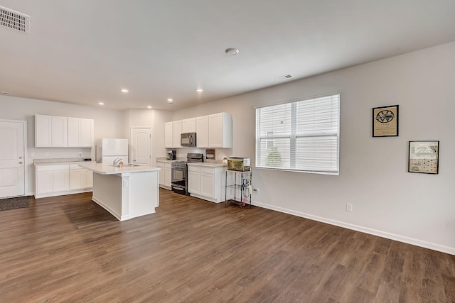 18 Pointer Pl, Lebanon, TN 37087 - kitchen with range with gas stovetop, black microwave, dark wood-style floors, light countertops, and recessed lighting
