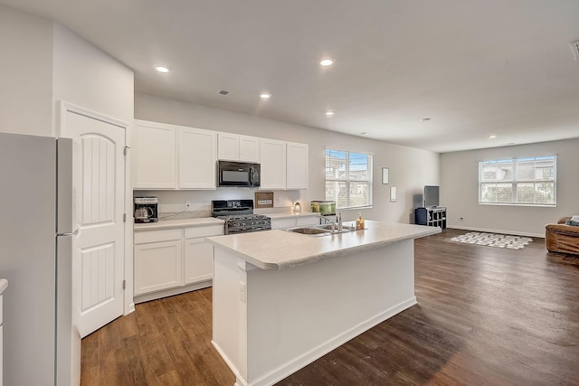 18 Pointer Pl, Lebanon, TN 37087 - kitchen featuring freestanding refrigerator, range with gas stovetop, black microwave, dark wood finished floors, and open floor plan