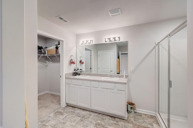 18 Pointer Pl, Lebanon, TN 37087 - bathroom with double vanity, a walk in closet, a stall shower, and stone finish floors
