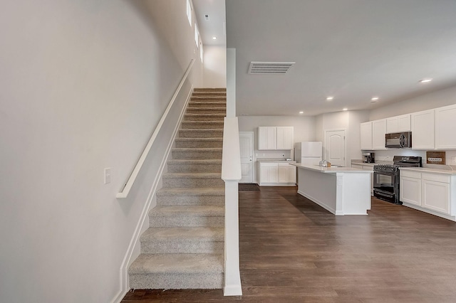 18 Pointer Pl, Lebanon, TN 37087 - kitchen featuring black appliances, light countertops, white cabinetry, dark wood finished floors, and recessed lighting