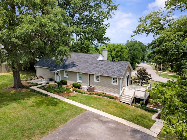 901 Edgewood Dr, Columbia, TN 38401 - view of front facade featuring a chimney, a deck, a shingled roof, and a front yard