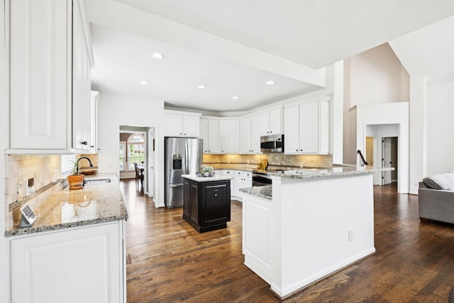 119 Abercairn Dr, Franklin, TN 37064 - kitchen with stainless steel appliances, a sink, backsplash, light stone countertops, and white cabinetry