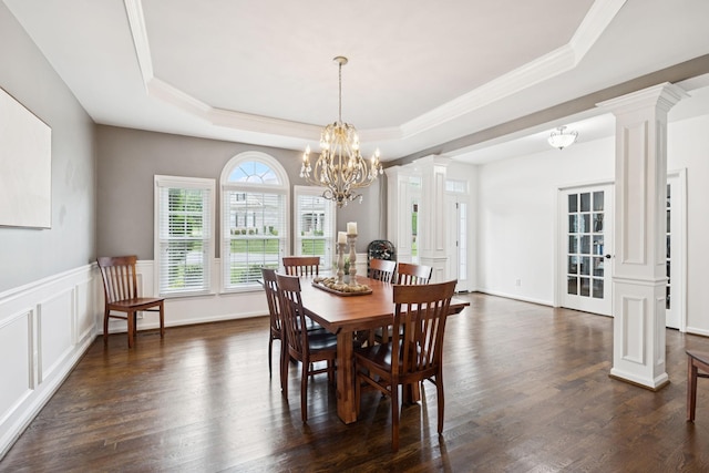 119 Abercairn Dr, Franklin, TN 37064 - dining room featuring ornate columns, a tray ceiling, dark wood-type flooring, a chandelier, and ornamental molding