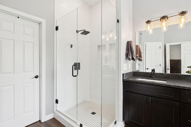 119 Abercairn Dr, Franklin, TN 37064 - bathroom featuring a stall shower, vanity, wood finished floors, and baseboards