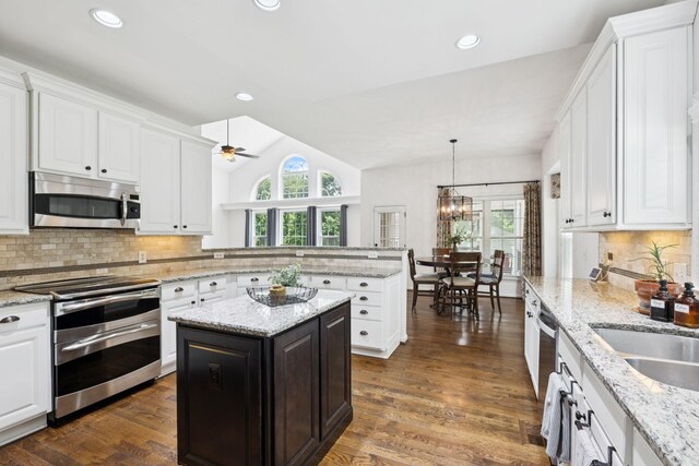 119 Abercairn Dr, Franklin, TN 37064 - kitchen featuring appliances with stainless steel finishes, a peninsula, white cabinets, ceiling fan, and vaulted ceiling