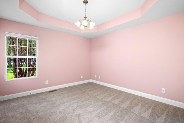 2520 Johnson Ridge Rd, Antioch, TN 37013 - spare room featuring a chandelier, carpet flooring, baseboards, and a raised ceiling